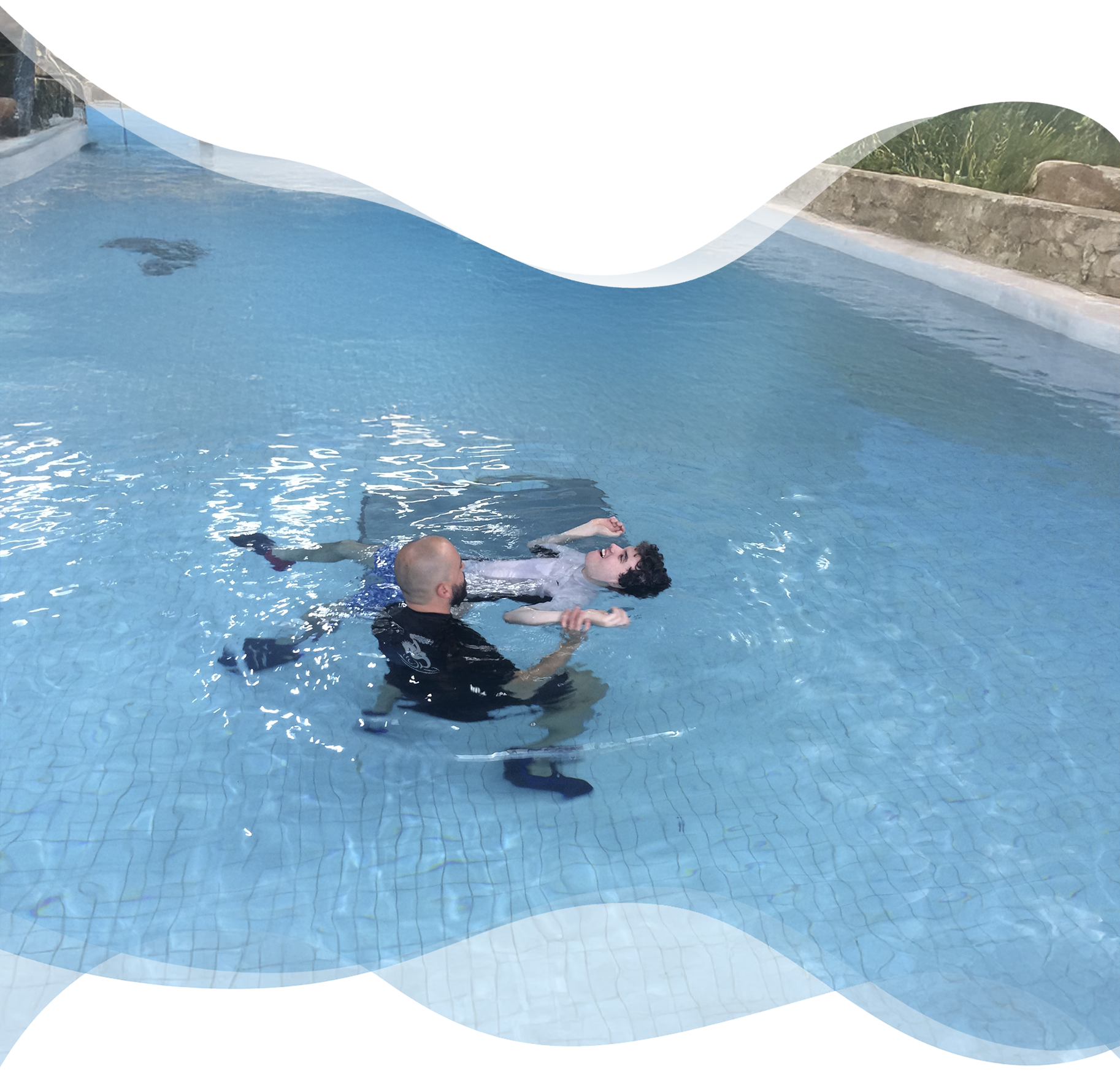 Nereids swim teacher supporting a student with autism floating independently in a calm, indoor pool environment.