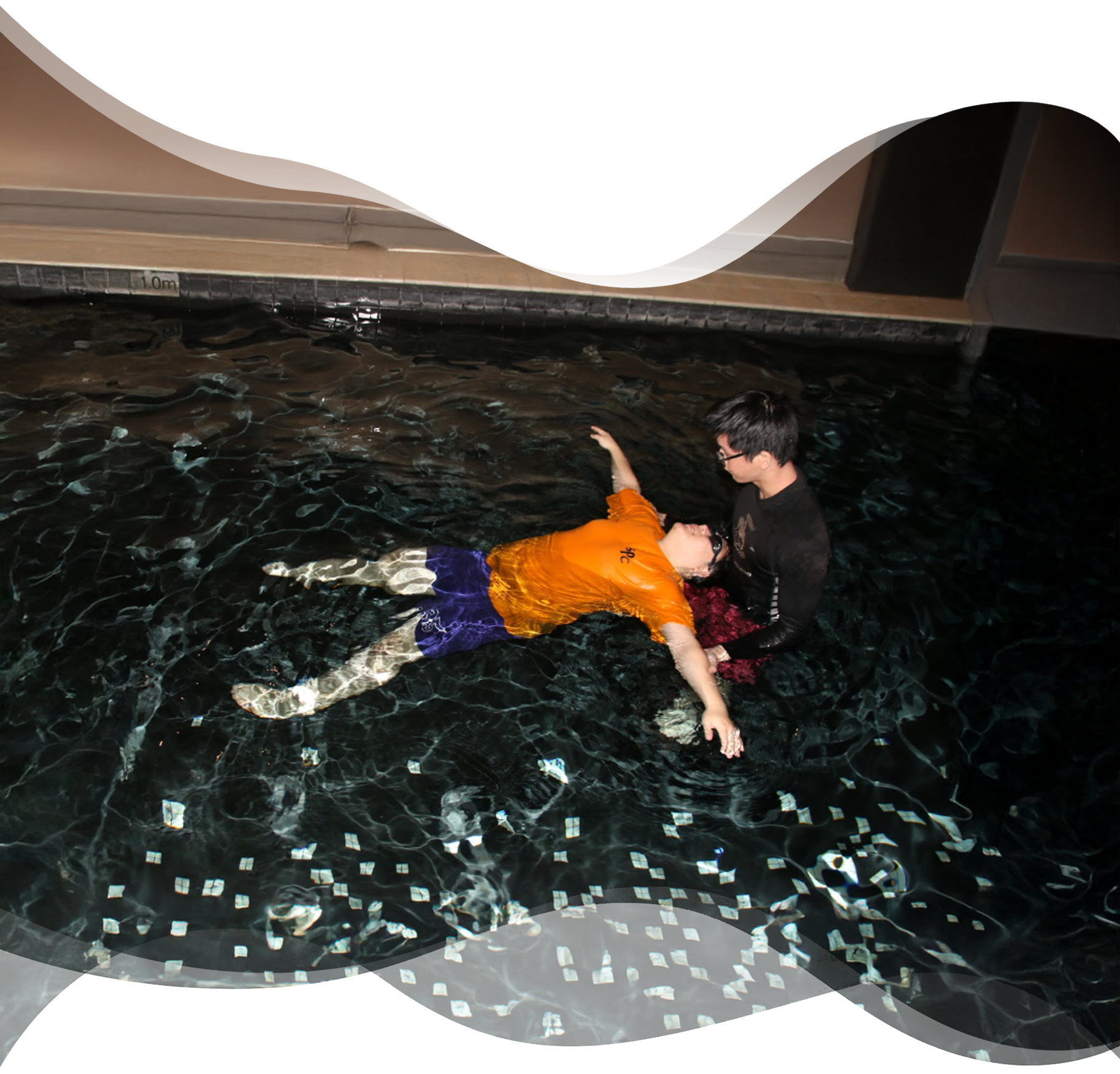 An adult learning to float in a starfish position while a Nereids swim teacher gently supports their elbows from behind, building trust, calm, and body awareness during a private swimming lesson.