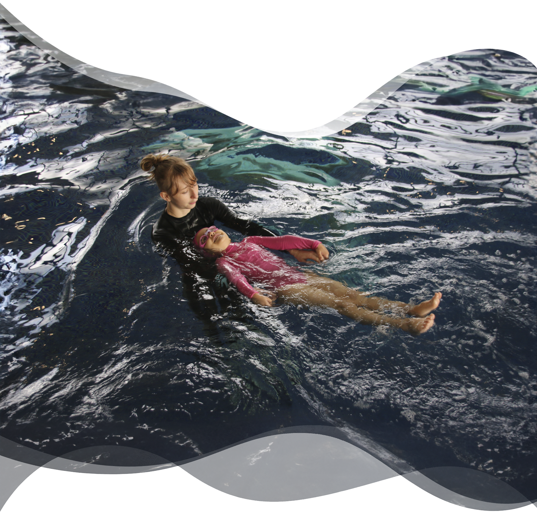 Preschool girl swimming confidently on her back while a Nereids swim teacher gently supports her, highlighting trust, comfort, and early independence in the water.