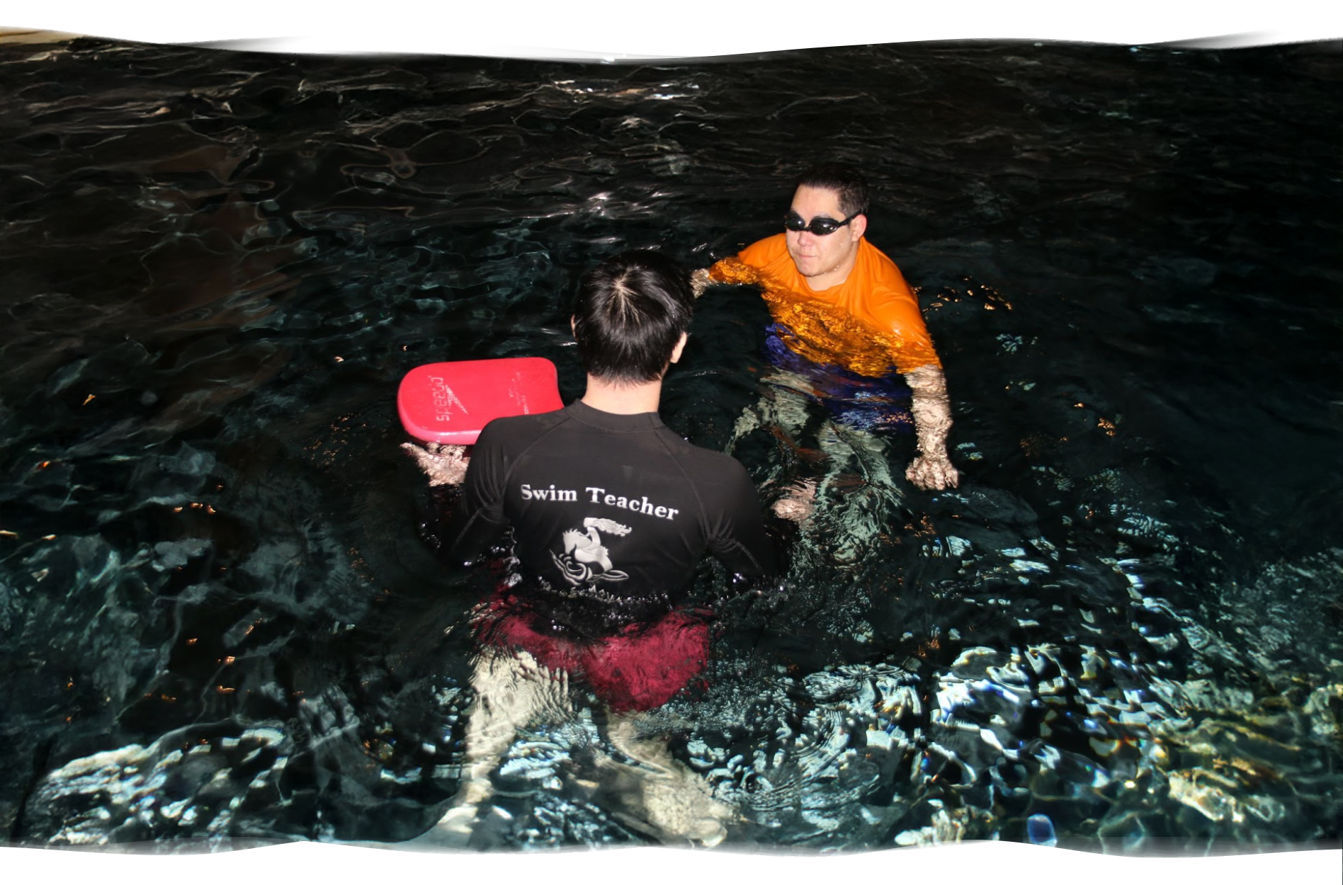 Nereids swim teacher giving calm instructions to an adult beginner focused on learning