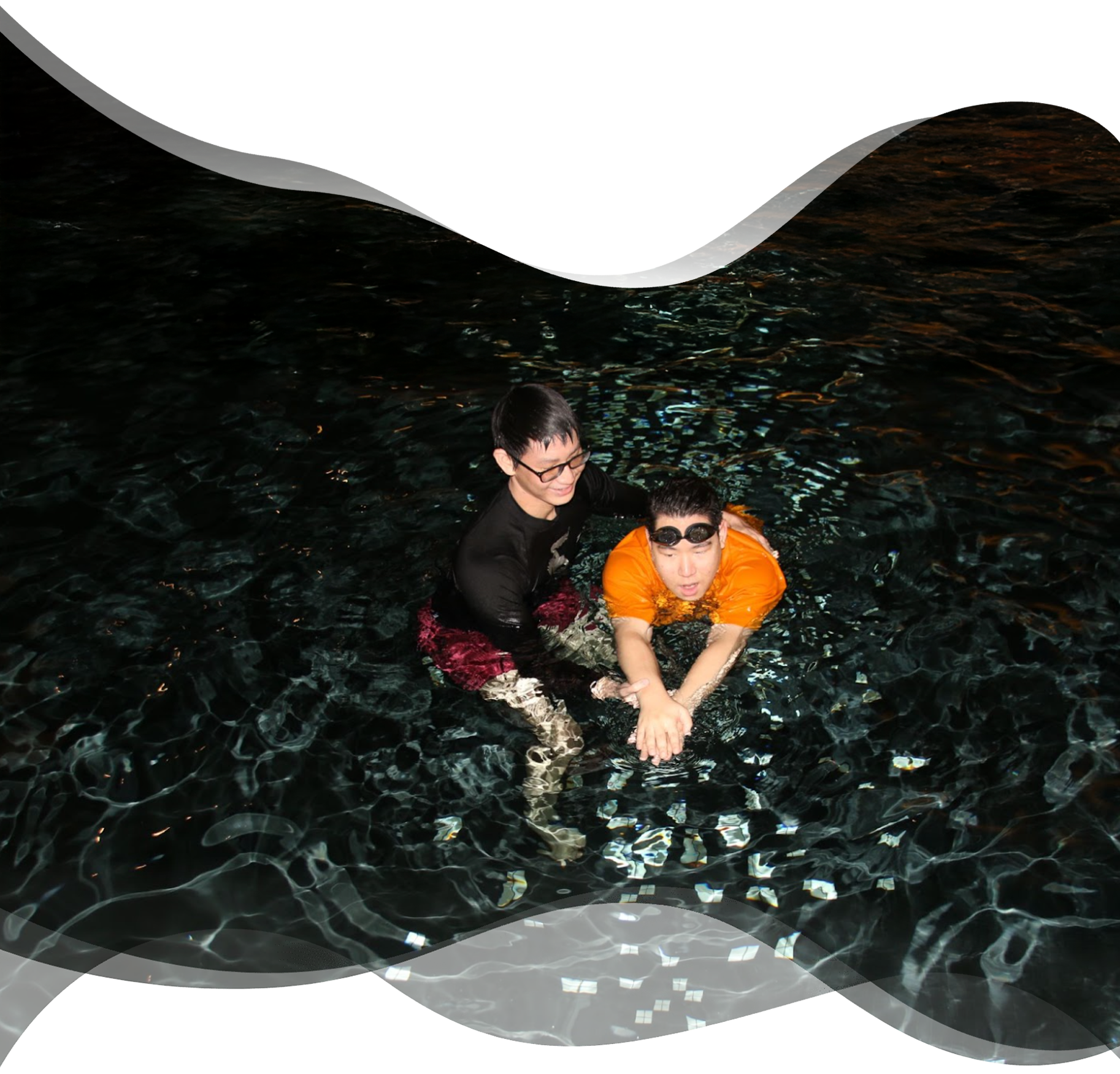 Adult beginner gliding forward with head above water while Nereids swim teacher supports the movement gently
