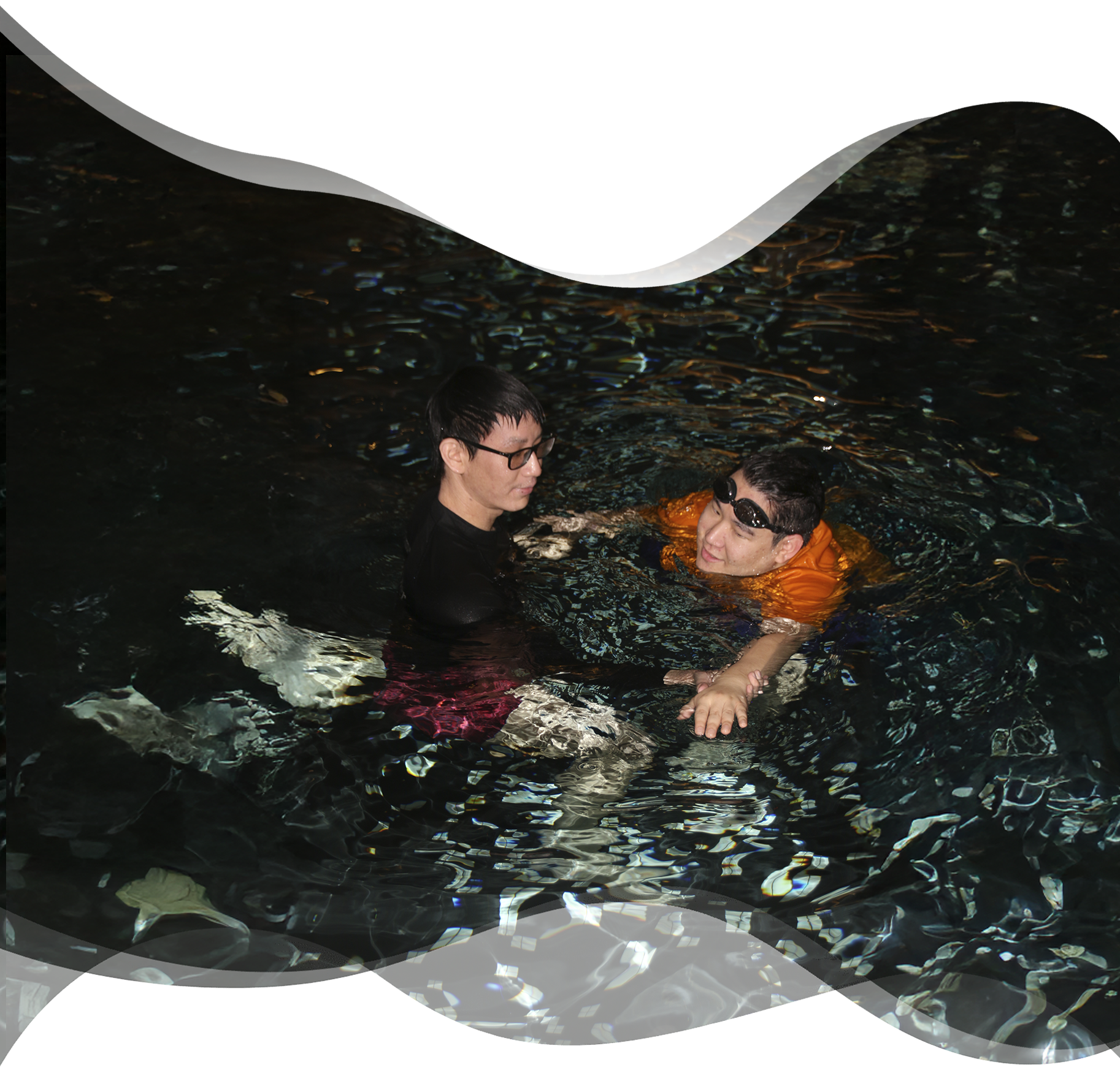 Nereids swim teacher giving calm instructions to an adult beginner focused on learning